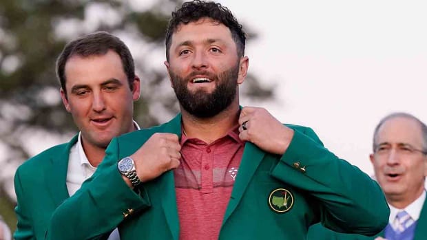 Jon Rahm slips on the green jacket after winning the 2023 Masters.